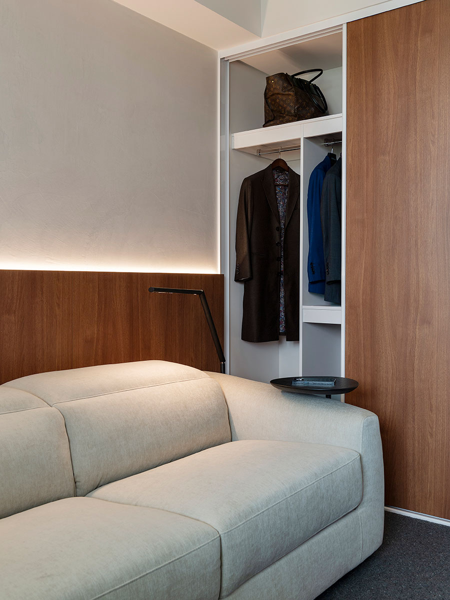 White sofa in a compact space with a small closet.